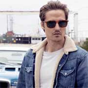 The Serengeti Lenwood on male model with car and industrial city backdrop